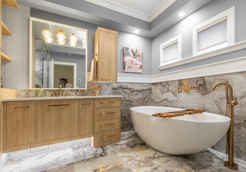 Vanity sconce and recessed lighting in a marble ensuite by North Star Electric in Winnipeg, Manitoba