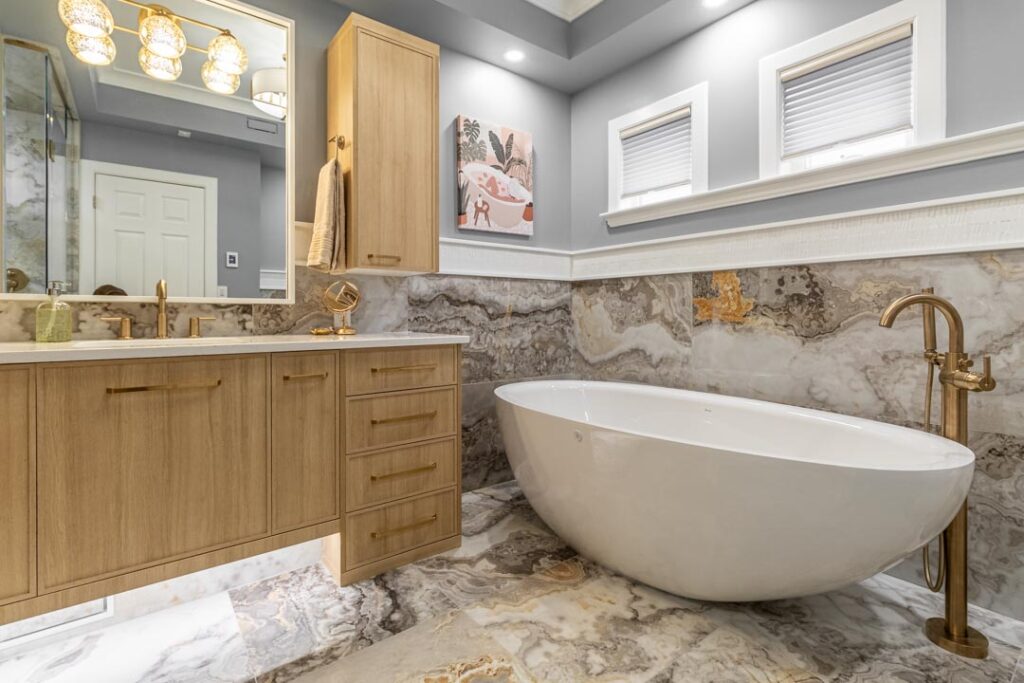 Wall sconce lighting beside a freestanding tub by North Star Electric in Winnipeg, Manitoba