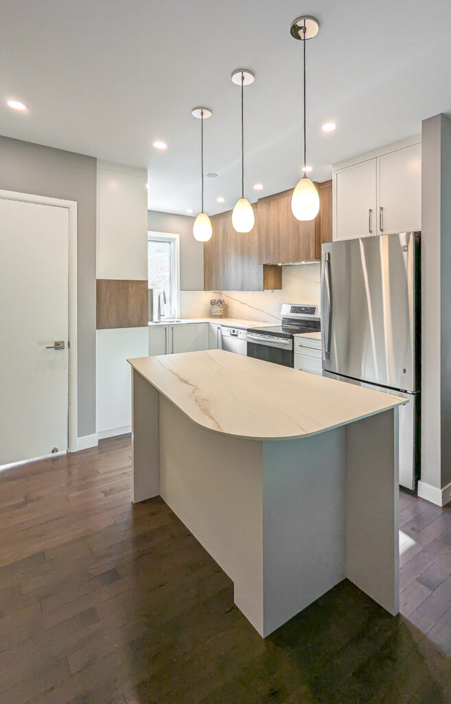 Three pendant lights over a kitchen island by North Star Electric in Winnipeg, Manitoba
