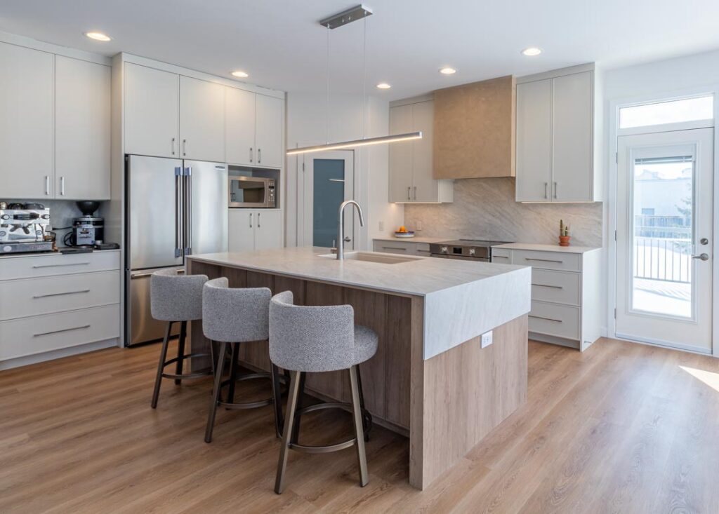 Recessed pot lights over a kitchen island by North Star Electric in Winnipeg, Manitoba